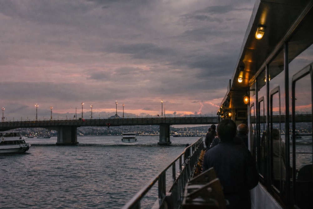 Dinner cruise boat on the Seine with illuminated bridges at dusk, no text, no logos, no people