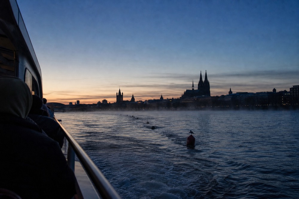 Early evening Seine river cruise with twilight sky and Notre-Dame silhouette, no text, no logos, no people