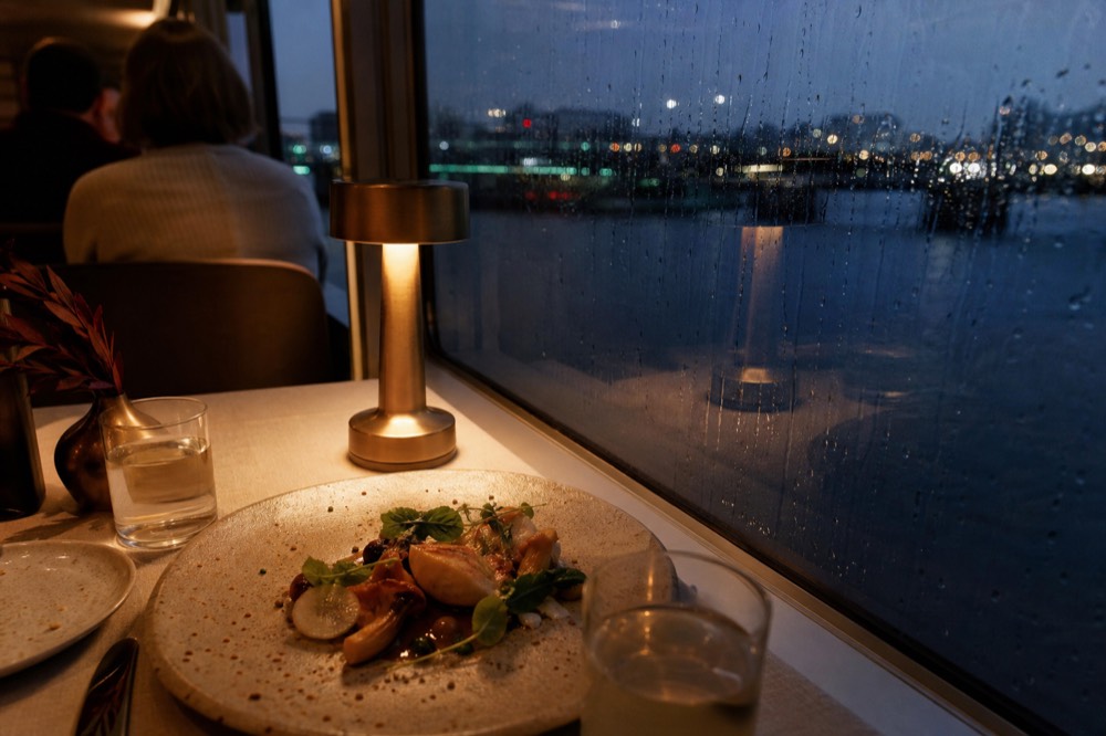 Plated dinner course on a cruise table, no text, no logos, no people