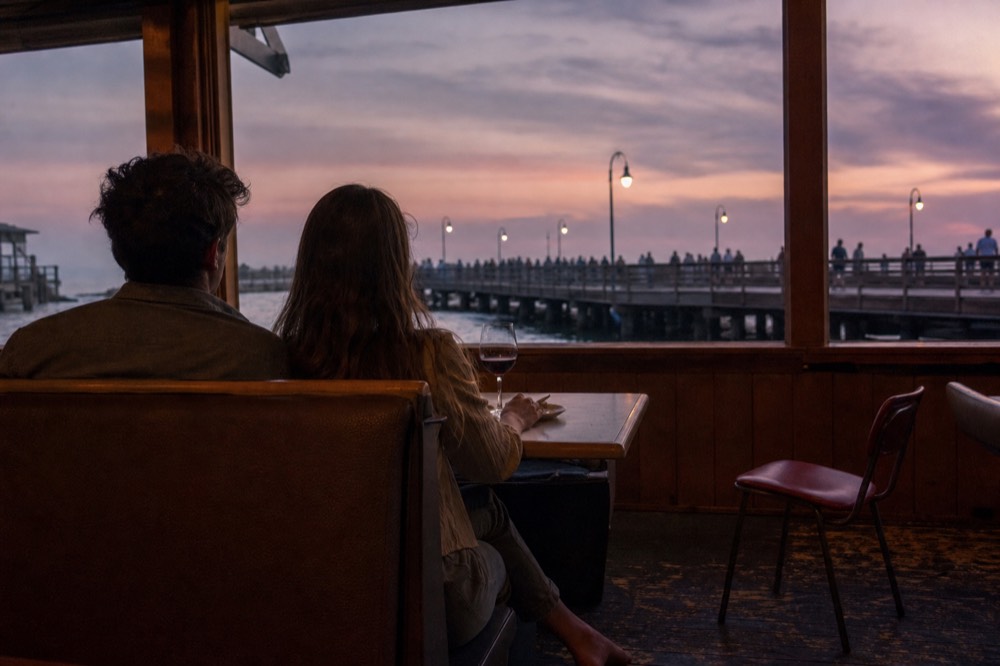 Couple dining by the window on a Seine dinner cruise, no text, no logos, no people