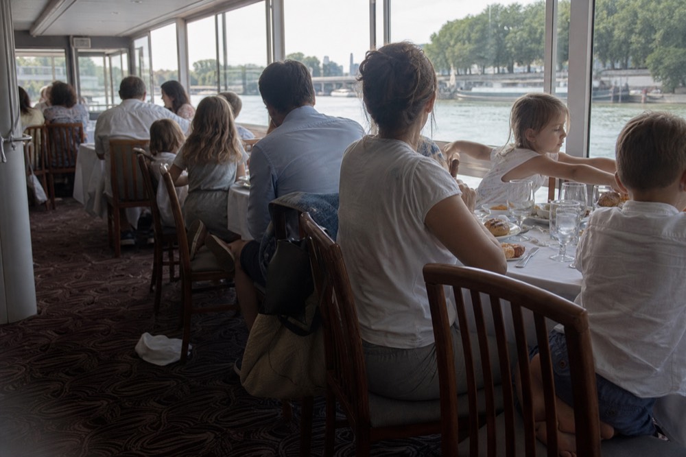 Group enjoying dinner on a Seine cruise, no text, no logos, no people