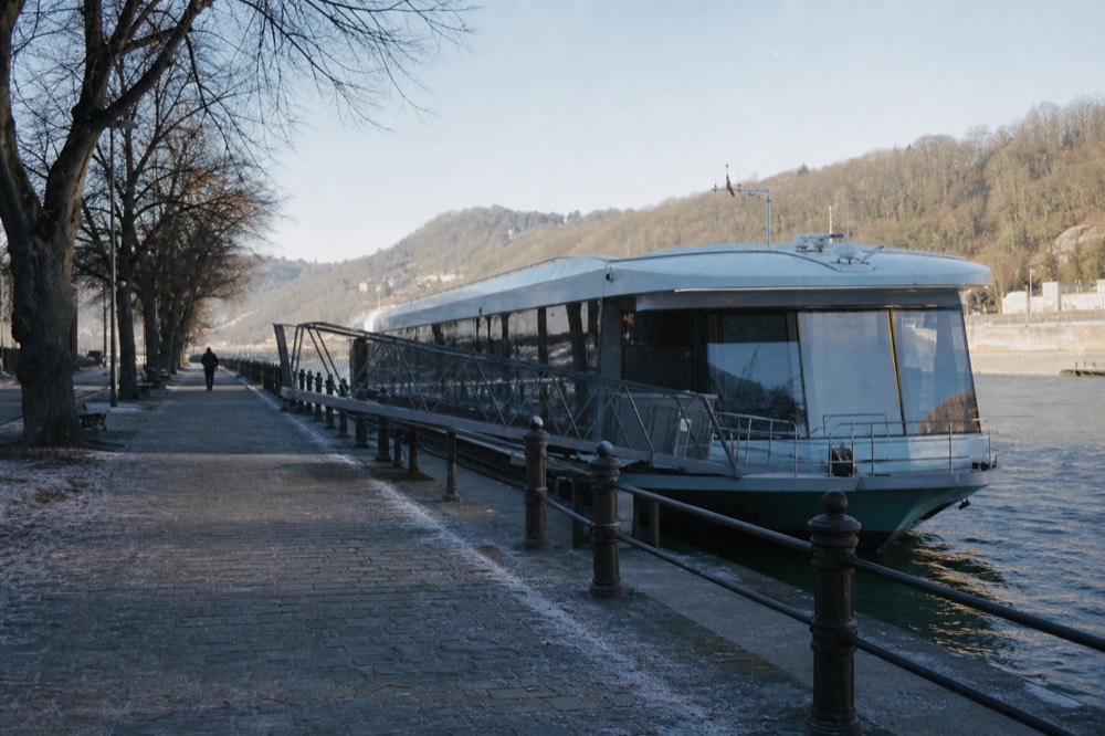 Ducasse-sur-Seine boat moored at quiet quay with modern gangway, no text, no logos, no people