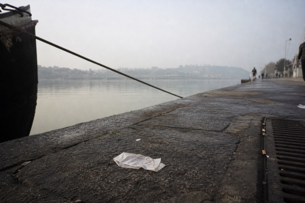 Ticket stub and Seine quay with directional sign, no text, no logos, no people