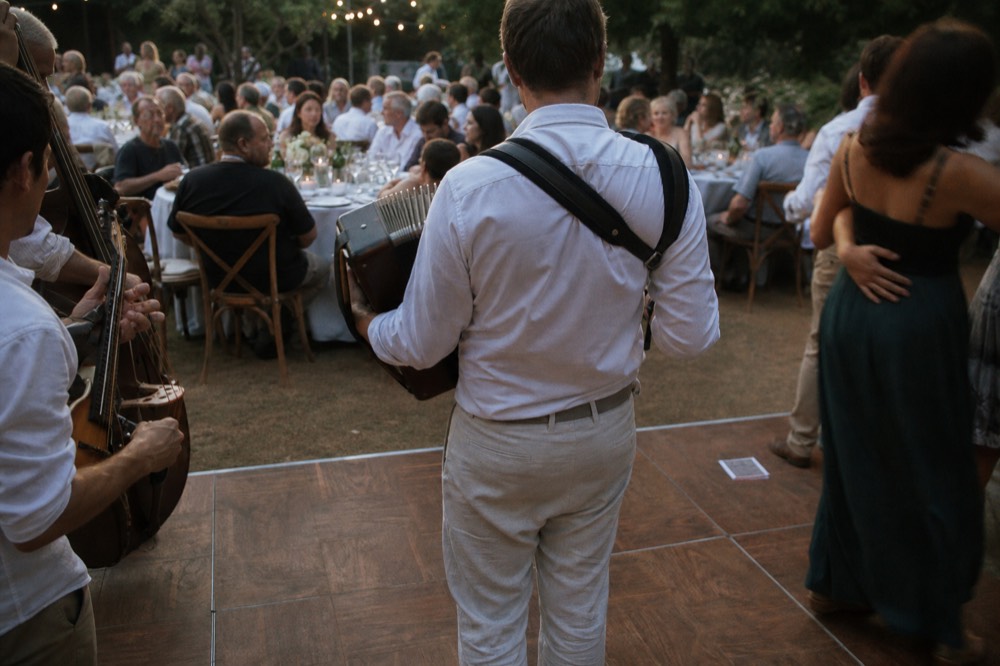 A live band performing among dining tables on a Seine dinner cruise, no text, no logos, no people.